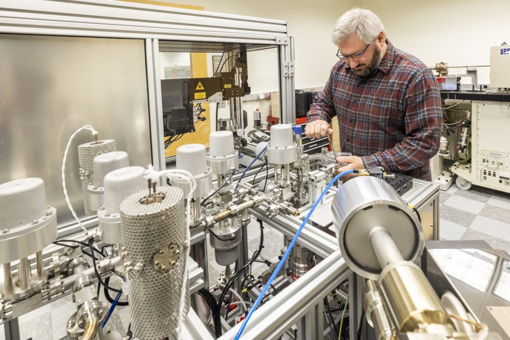 Research assistant professor Florian Hofmann of the UAF Geophysical Institute’s Geochronology Lab works on the lab’s argon mass spectrometer. Photo by JR Ancheta